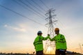 Team work of Engineers and Technician join hands for success after work inspections at the electric power station, electricity