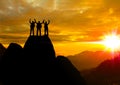 Team work Silhouette photo.They are show hand and standing on cliff. Royalty Free Stock Photo