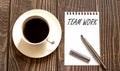 TEAM WORK - white paper with pen and coffee on wooden background Royalty Free Stock Photo