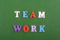 TEAM WORK word on green background composed from colorful abc alphabet block wooden letters, copy space for ad text. Learning Royalty Free Stock Photo