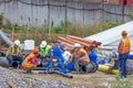 Workers at break and collect pipeline.