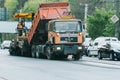 Ternopil, Ukraine, May 2020: Team of workers in protective uniforms work on road construction. Workers transportation Royalty Free Stock Photo