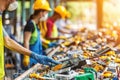 Team of Workers at Waste Sorting Table Examining Electronic Waste for Recycling Processing Royalty Free Stock Photo