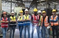 Team Workers and workers are standing in the factory. Group Staff Standing In Engineering Factory Royalty Free Stock Photo