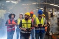 Team Workers and workers are standing in the factory. Group Staff Standing In Engineering Factory Royalty Free Stock Photo