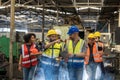 Team Workers and workers are standing in the factory. Group Staff Standing In Engineering Factory Royalty Free Stock Photo