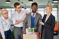 Team of workers support their colleague leaving work