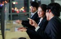 Team of workers wearing headphone headset and working with happy face in front of computer screen at call center in office with Royalty Free Stock Photo