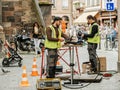 Team working near open manhole installing fiber optic