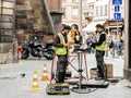 Team working near open manhole installing fiber optic