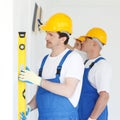 Team of workmen align wall Royalty Free Stock Photo