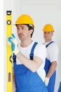 Team of workmen align wall Royalty Free Stock Photo