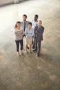 The team you can depend on. High angle portrait of a group of businesspeople standing together in an office lobby. Royalty Free Stock Photo