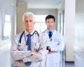 The team you can trust. Portrait of two serious doctors standing in a hospital corridor. Royalty Free Stock Photo