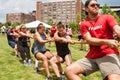 Team Of Young Adults Pulls Rope In Tug Of War