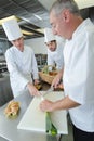 Team young apprentice chefs preparing delicatessen dishes Royalty Free Stock Photo