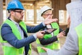 Team of young architects discussing and arguing during a meeting on a construction site