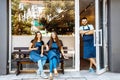 A team of young barists near a cafe