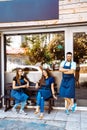 A team of young barists near a cafe