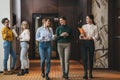 Team of young coworkers meeting while they go around business center hall Royalty Free Stock Photo