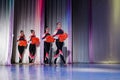 team of young girls - athletes are preparing for the show, many young cheerleaders are standing on stage behind the curtain Royalty Free Stock Photo