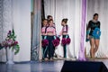 Team of young girls - athletes are preparing for the show, many young cheerleaders are standing on stage behind the curtain, sport Royalty Free Stock Photo