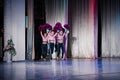 team of young girls - athletes are preparing for the show, many young cheerleaders are standing on stage behind the curtain, sport Royalty Free Stock Photo