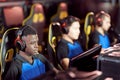 Team of young professional cybersport gamers wearing headphones participating in eSport tournament Royalty Free Stock Photo