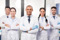 Team of young professional doctors standing together in laboratory posing Royalty Free Stock Photo