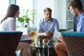 Team young professionals having casual discussion in office. Executives having friendly discussion during break. Royalty Free Stock Photo