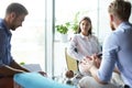 Team young professionals having casual discussion in office. Executives having friendly discussion during break. Royalty Free Stock Photo