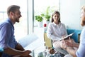 Team young professionals having casual discussion in office. Executives having friendly discussion during break. Royalty Free Stock Photo