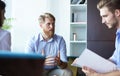 Team young professionals having casual discussion in office. Executives having friendly discussion during break. Royalty Free Stock Photo