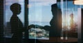 Teaming up with another great mind. Silhouette shot of two businesspeople shaking hands inside an office building.