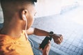 Teaming up with tech to take on a workout challenge. a man pairing his watch with a smartphone during a workout against