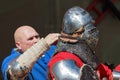 Teammate helping to put on the knight the armors before battle