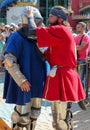 Teammate helping to put on the knight the armors before battle Royalty Free Stock Photo