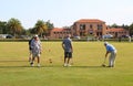 Teams of active senior citizens engaged in a game of lawn bowling at the Rotorua Bowling Club