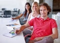 This teams creativity knows no bounds. Three creative professionals sitting in a line in their boardroom together.