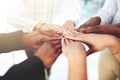Teamwork allows us all to shine. Closeup shot of a group of businesspeople joining their hands together in a huddle. Royalty Free Stock Photo