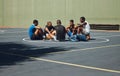 Teamwork, basketball and planning with friends relax on sports court for training, workout and fitness together