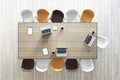 Teamwork and brainstorm concept with top view on wooden conference table with laptops and coffee mugs surrounded by white, brown