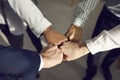 Diverse interracial people join hands fist bumping assembling together
