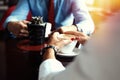 Teamwork. Businessman and businesswoman sitting at table in coffee shop and discuss business plan. On table is laptop Royalty Free Stock Photo