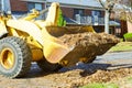 The teamwork on city improvement cleaning autumn leaves in the fallen leaves with a tractor