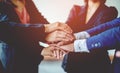 Close-up of young business people shaking hands. Demonstrates excellent work. laying hands to encourage work Unity and