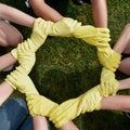 Teamwork and collaboration. Group of volunteers or eco activists wearing protective rubber gloves putting their hands