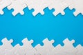 Teamwork, completing the final task and finding the solution concept with pieces of jigsaw puzzle creating a frame or border on Royalty Free Stock Photo