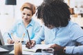 Teamwork concept of beautiful womans making business meeting in modern office. Group girls coworkers discussing together new Royalty Free Stock Photo