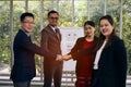 Businessman and woman standing and punch hands together in meeting room Royalty Free Stock Photo